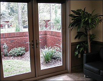The Consultation room is a beautiful room fitted with french doors that open up to a small garden.